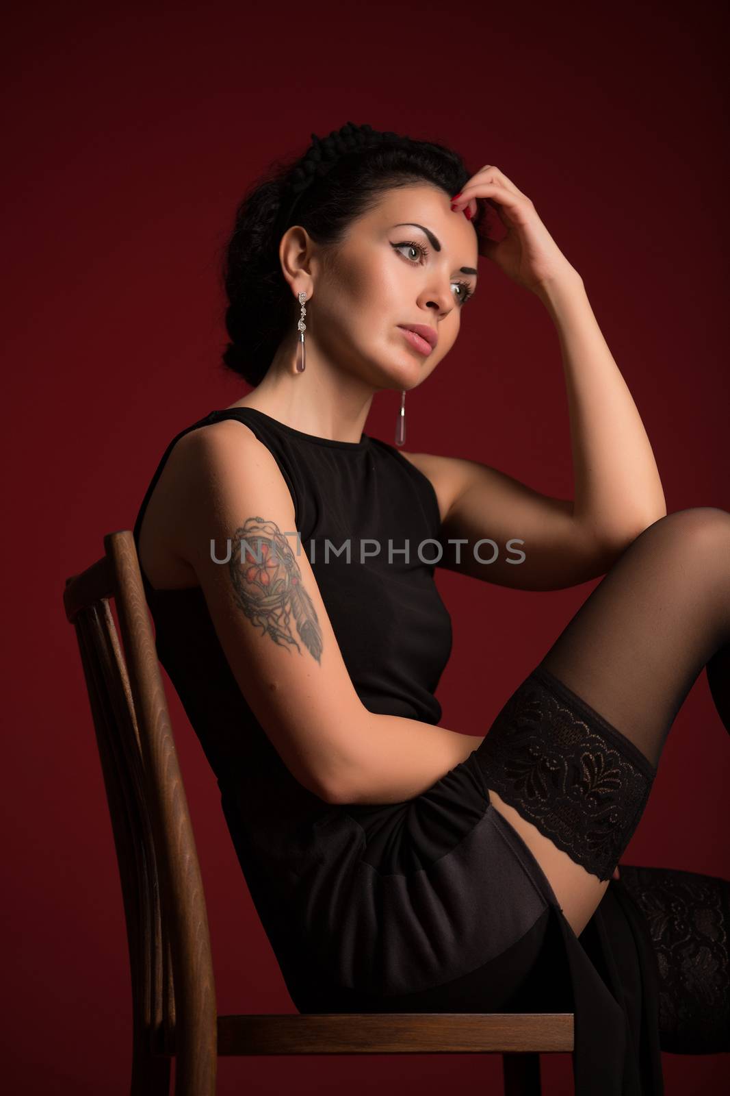 Studio portrait of a sexy brunette in black stockings by sarymsakov