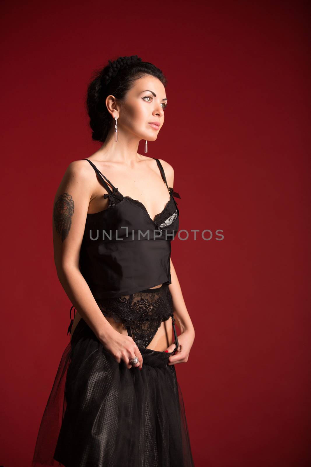 Studio portrait of a sexy brunette in black stockings by sarymsakov