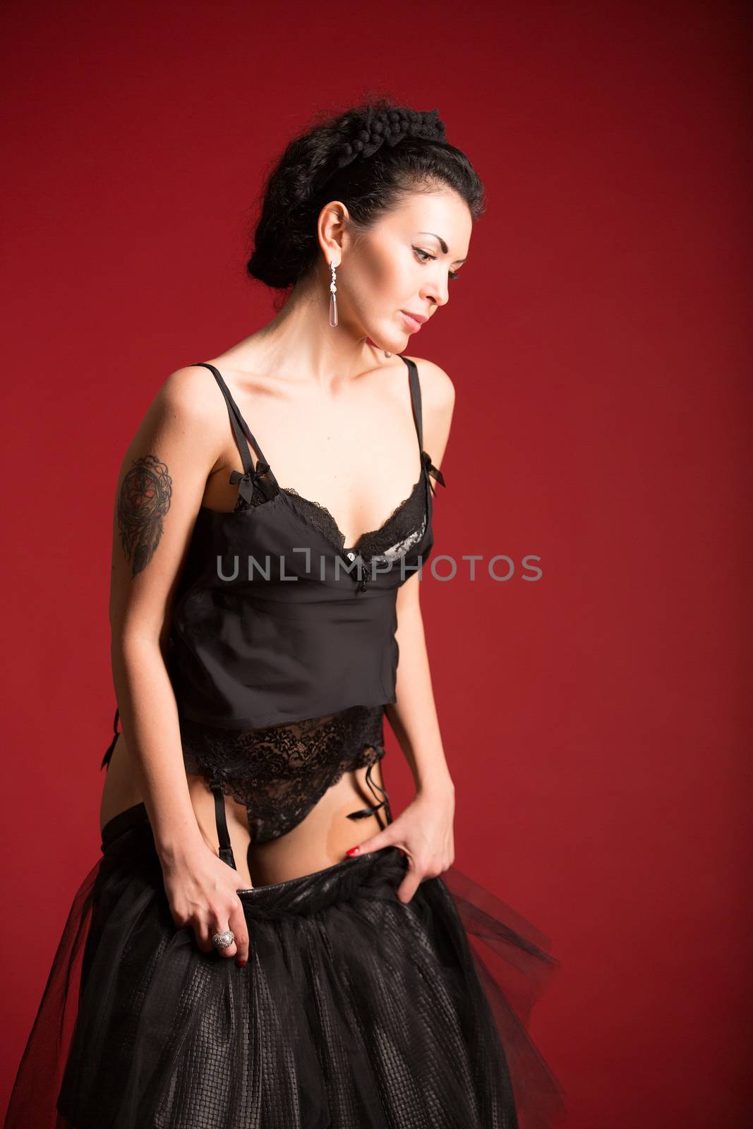 Studio portrait of a sexy brunette in black stockings by sarymsakov