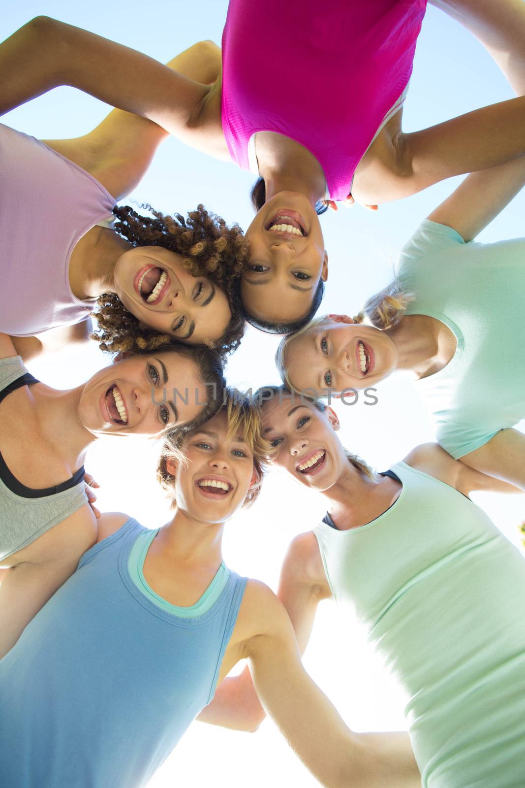 Fitness group standing in circle by Wavebreakmedia
