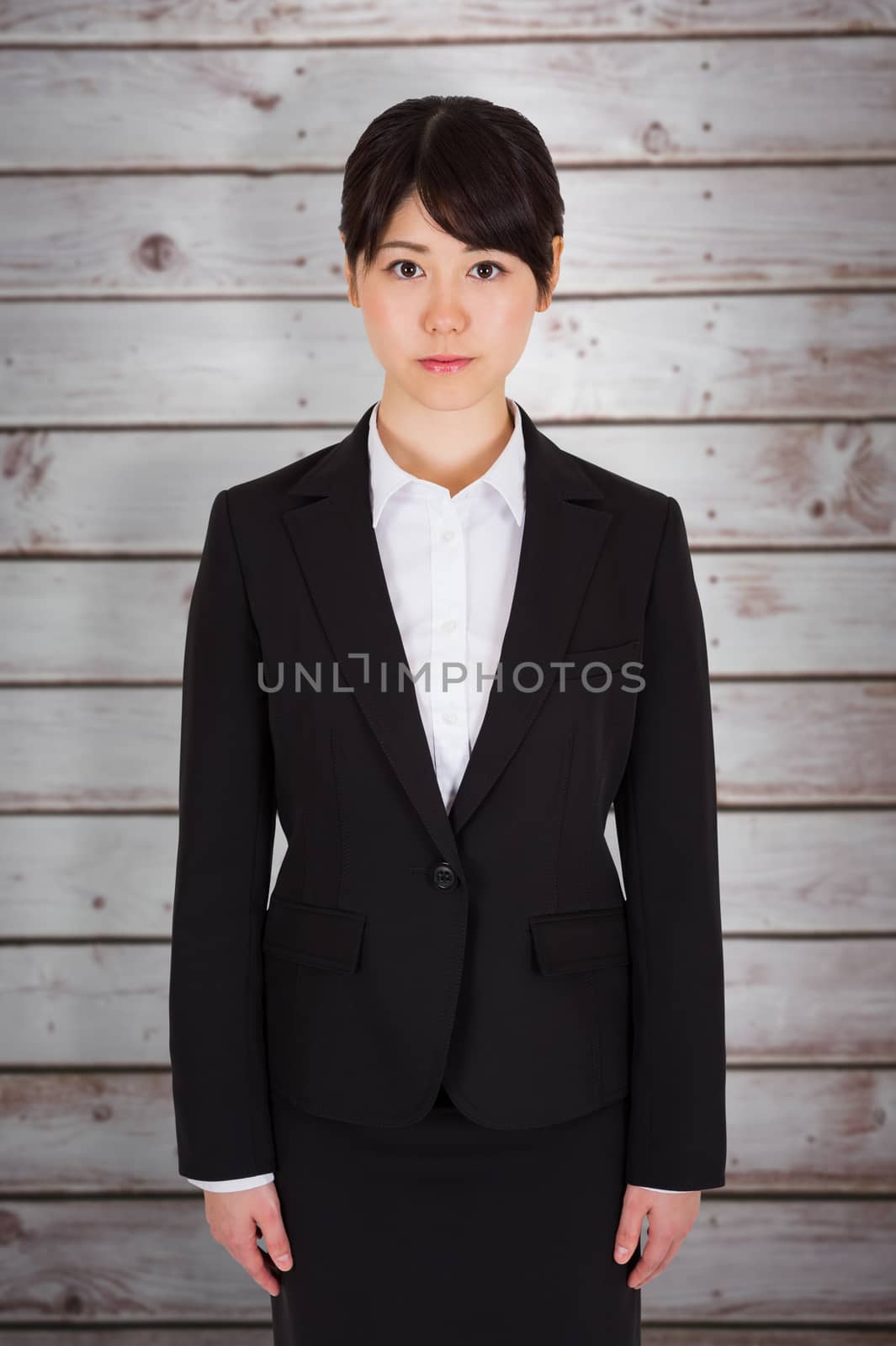 Serious businesswoman against wooden planks