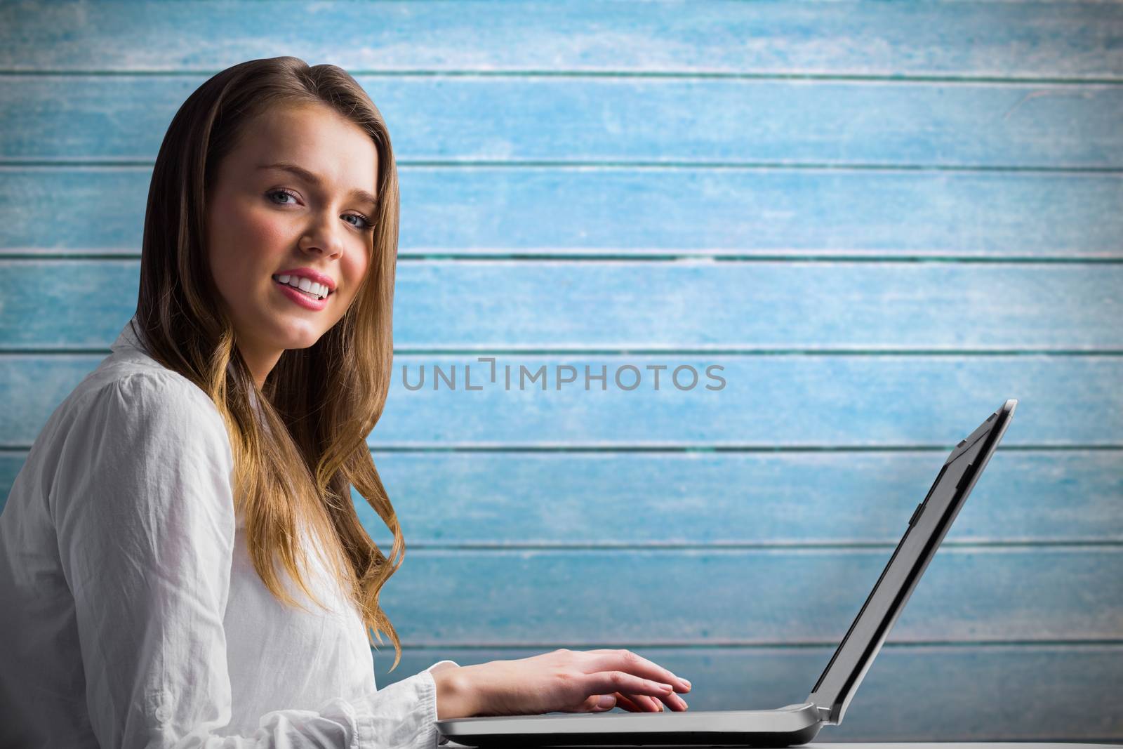 Composite image of businesswoman typing on her laptop by Wavebreakmedia