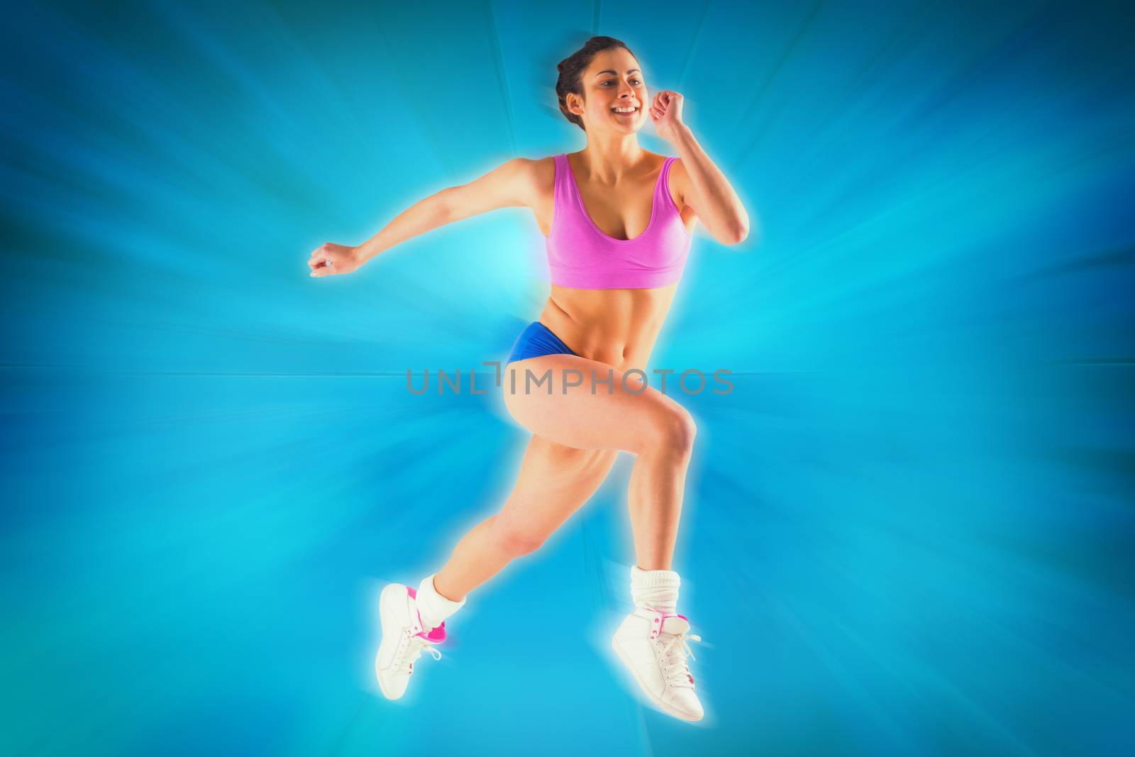 Fit brunette running and jumping against abstract background