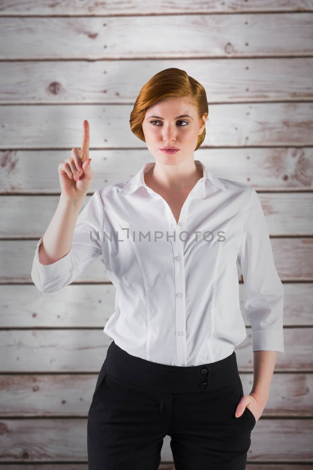 Businesswoman standing and pointing against wooden planks