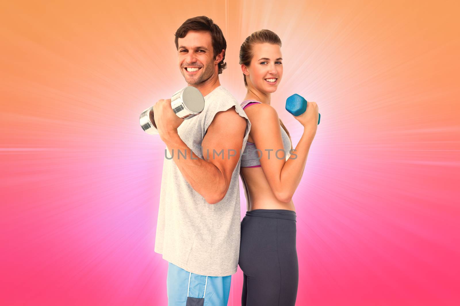 Portrait of a fit couple exercising with dumbbell against abstract background