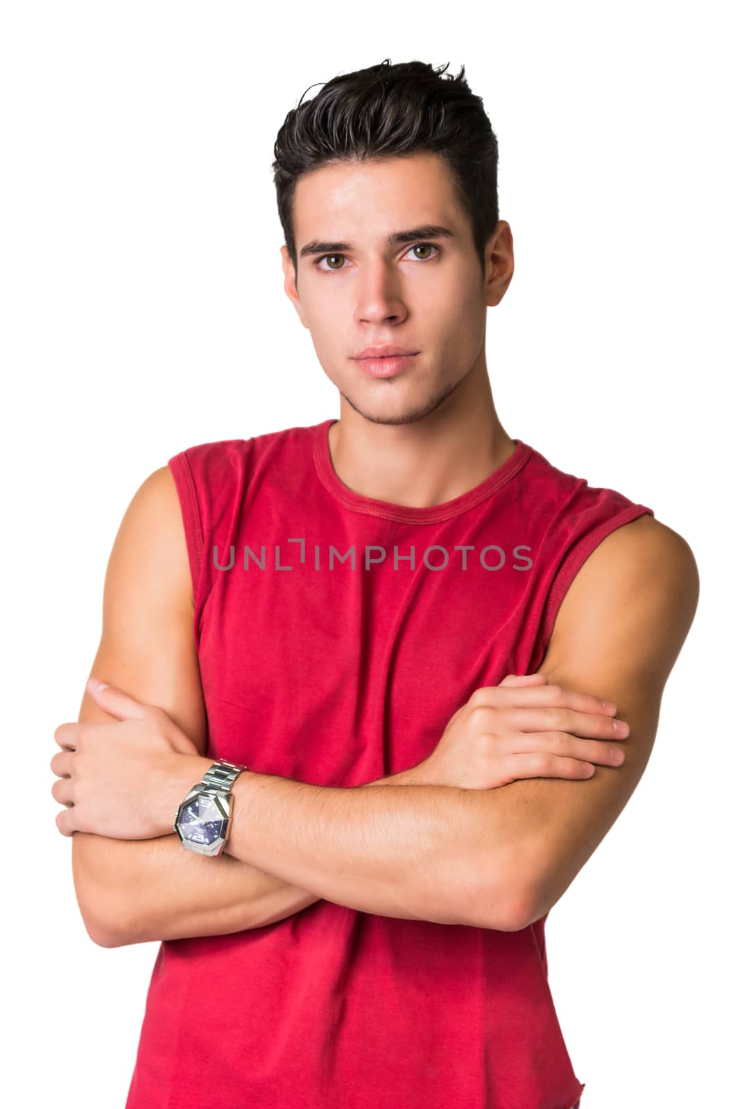 Serious looking young man wearing red t-shirt looking at camera isolated in white background