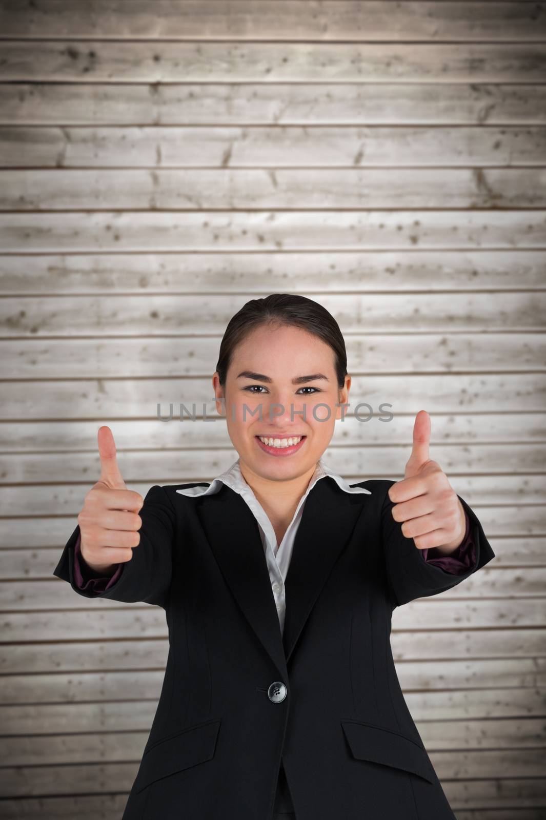 Happy businesswoman showing thumbs up against wooden planks background
