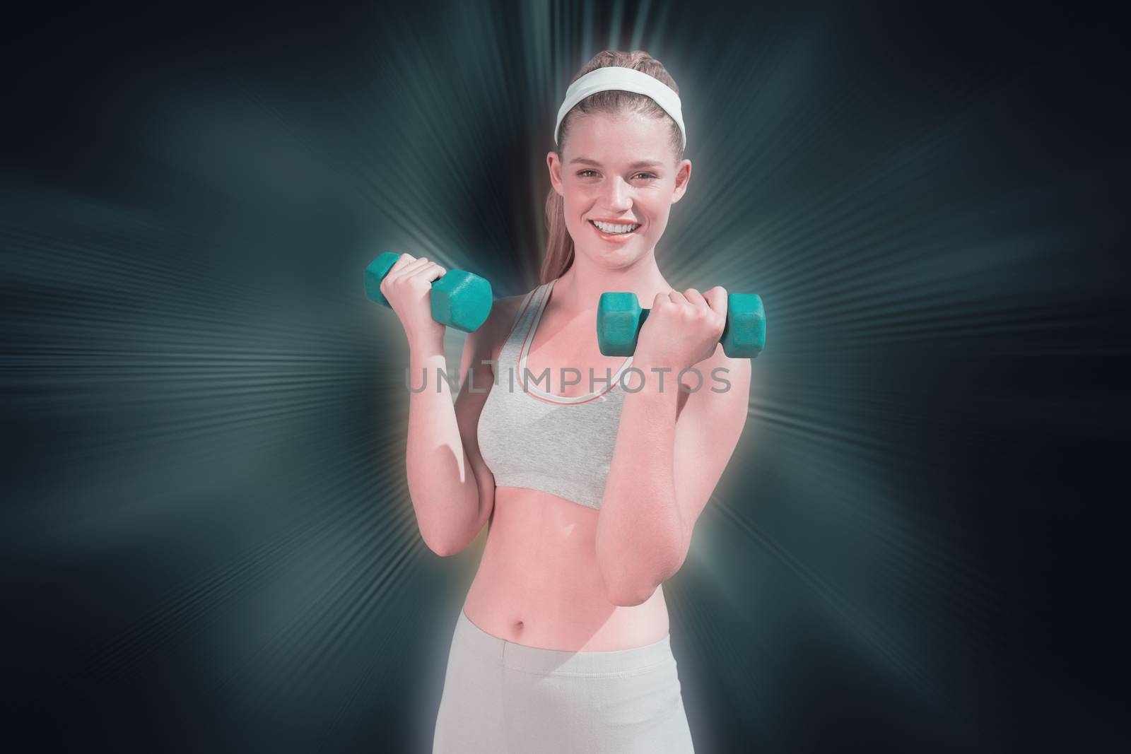 Sporty happy blonde lifting dumbbells on the beach  against abstract background