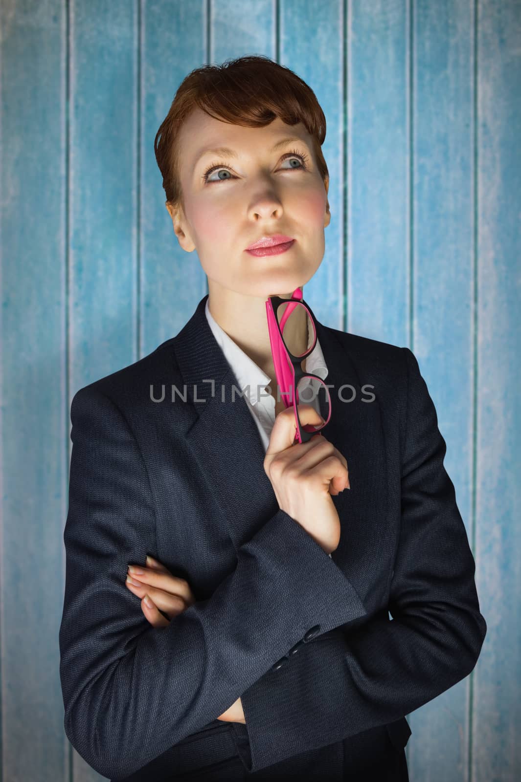 Thinking businesswoman against wooden planks