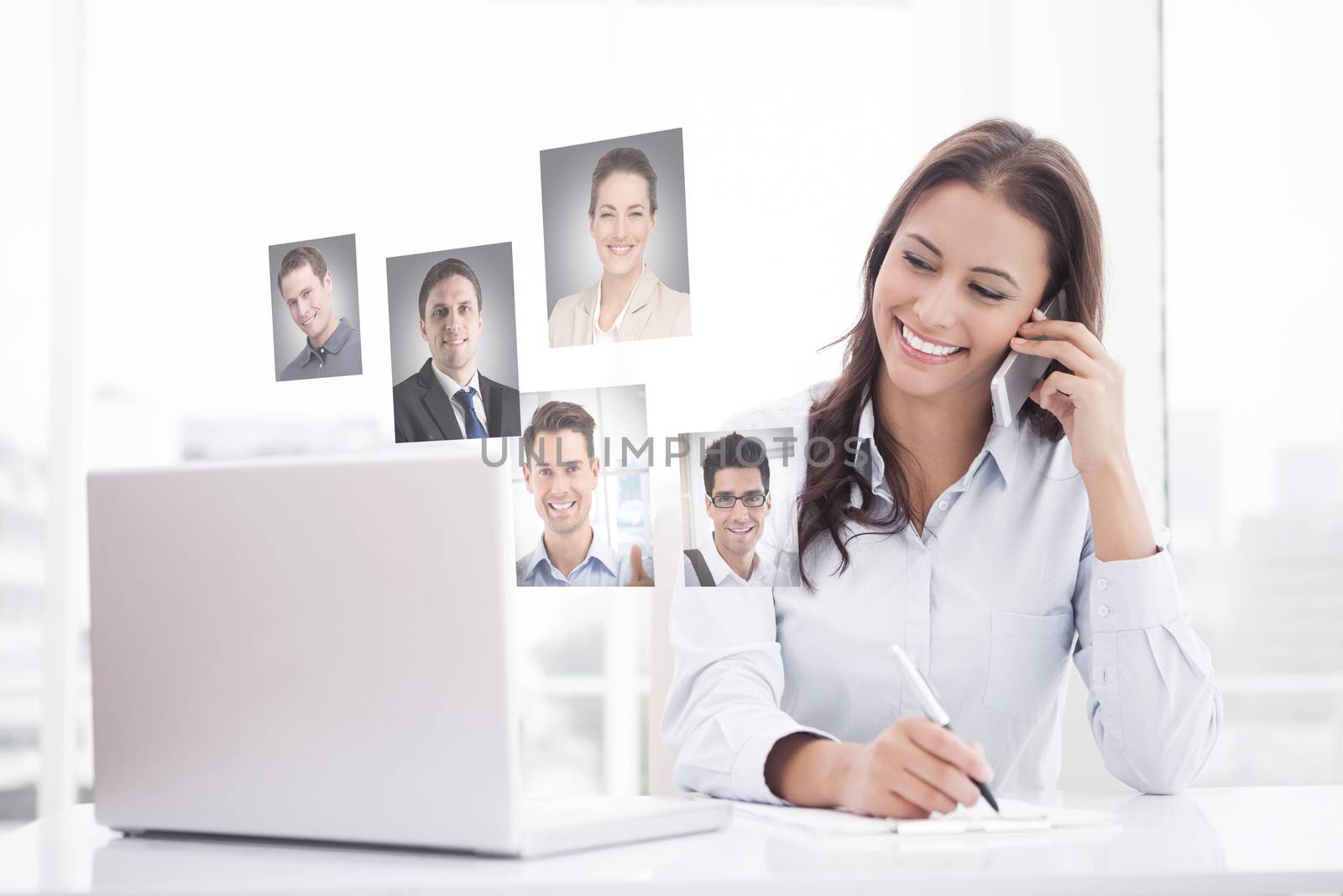 Composite image of happy businesswoman using laptop at her desk by Wavebreakmedia
