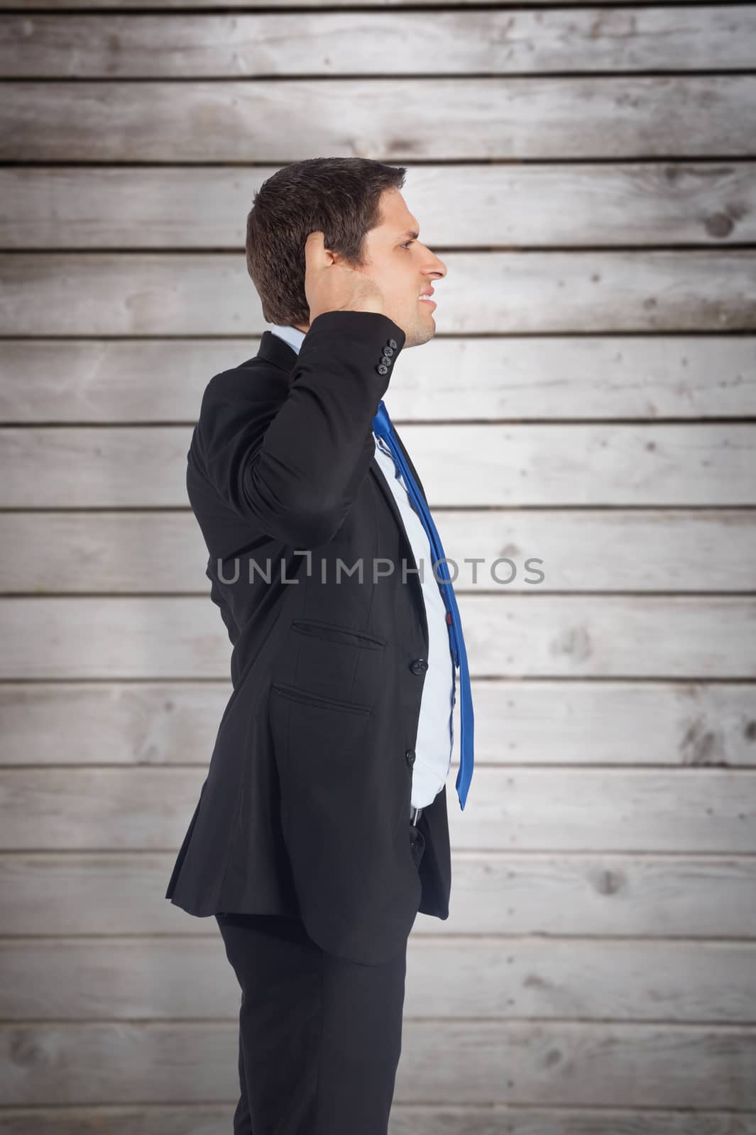 Composite image of thinking businessman scratching head by Wavebreakmedia