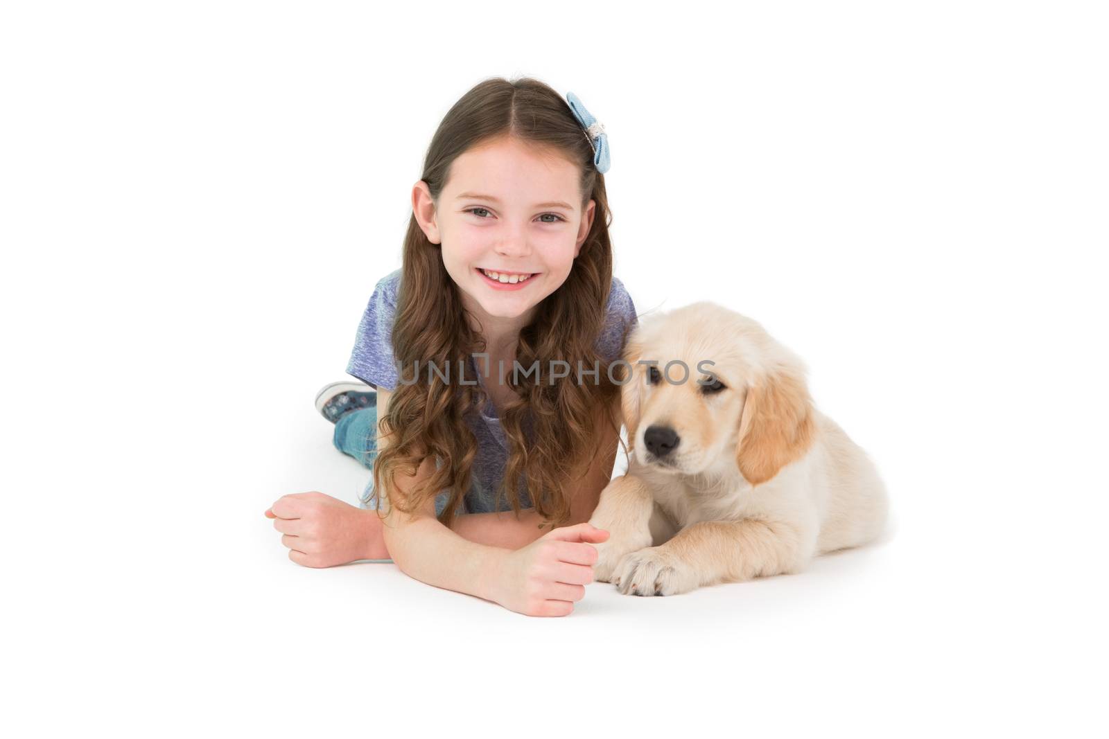 Lying little girl with a dog on white background 