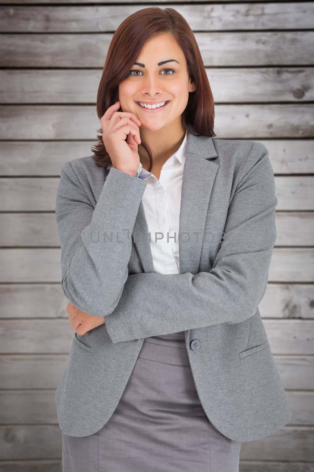 Smiling thoughtful businesswoman against wooden planks