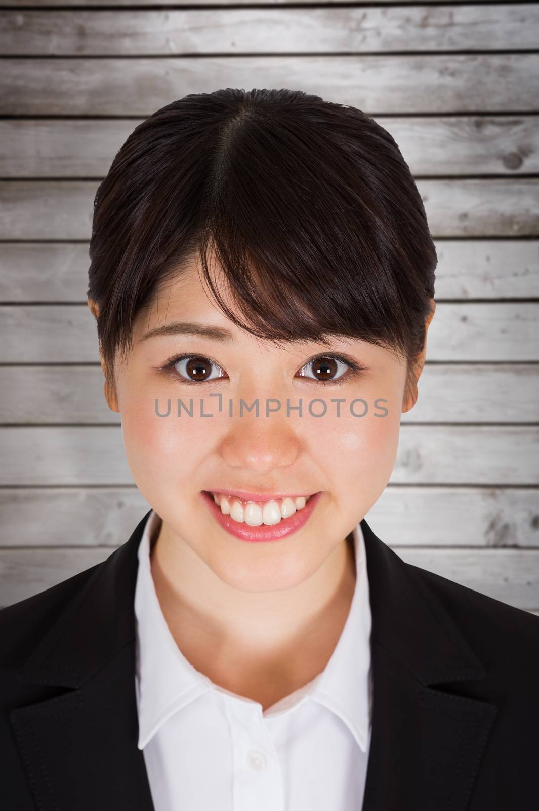 Smiling businesswoman against wooden planks