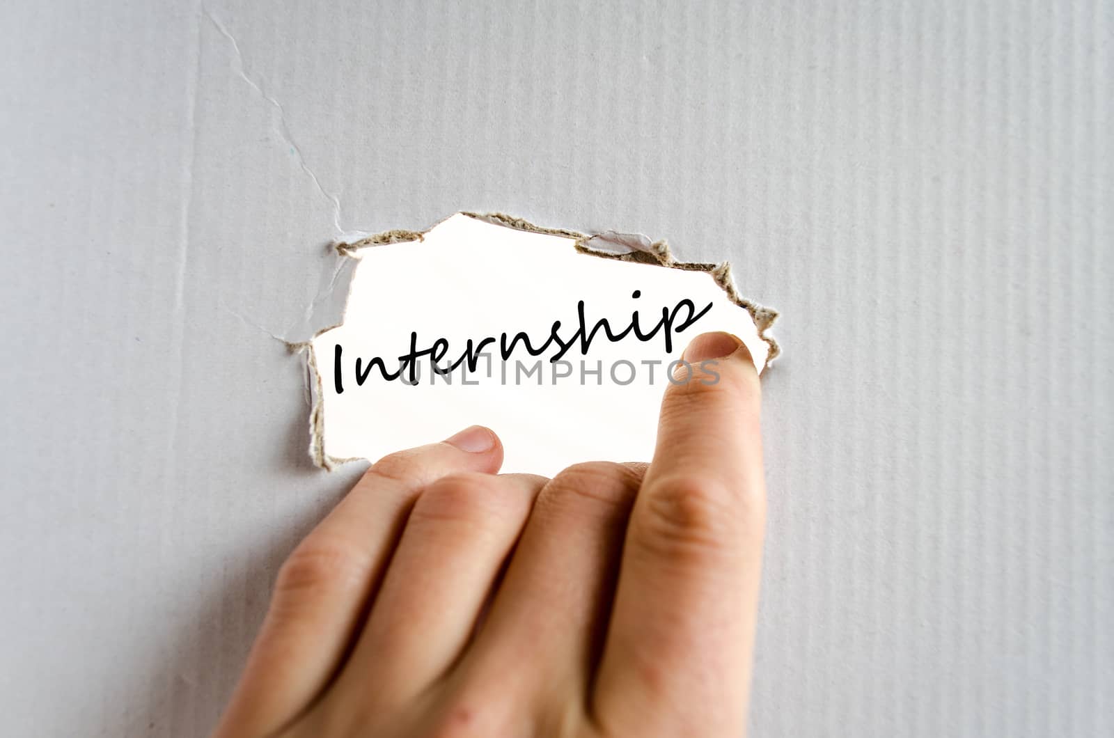 Hand on the cardboard background internship concept