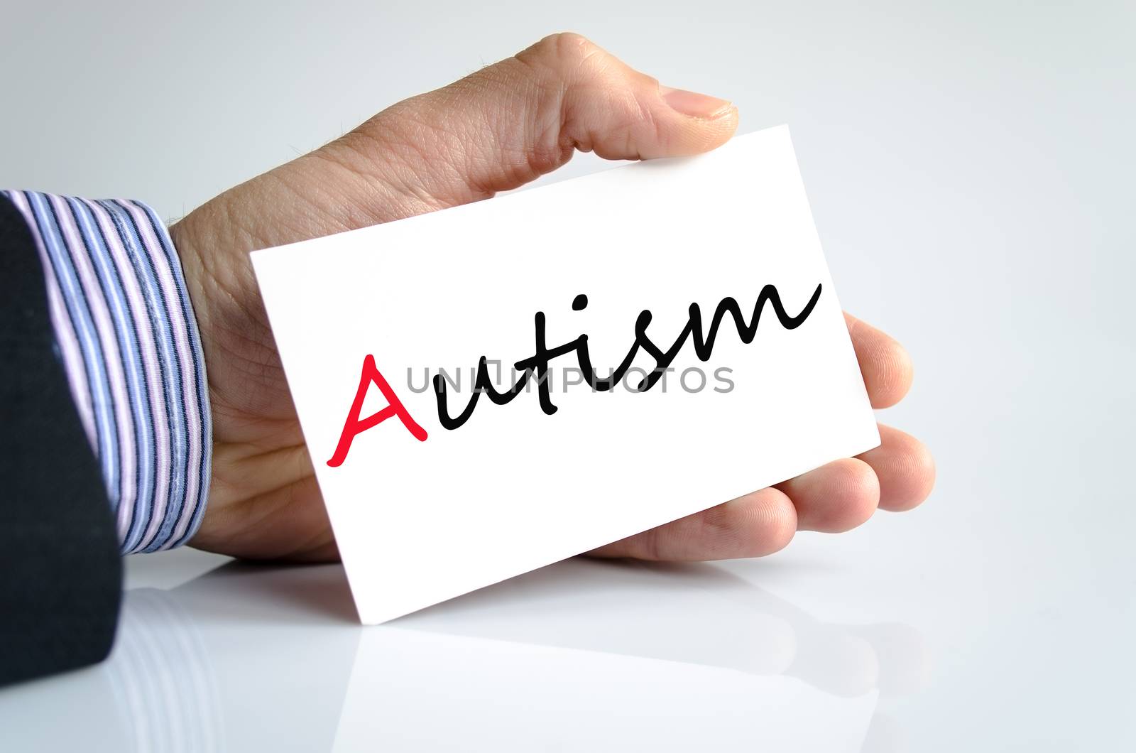 Business man hand writing autism