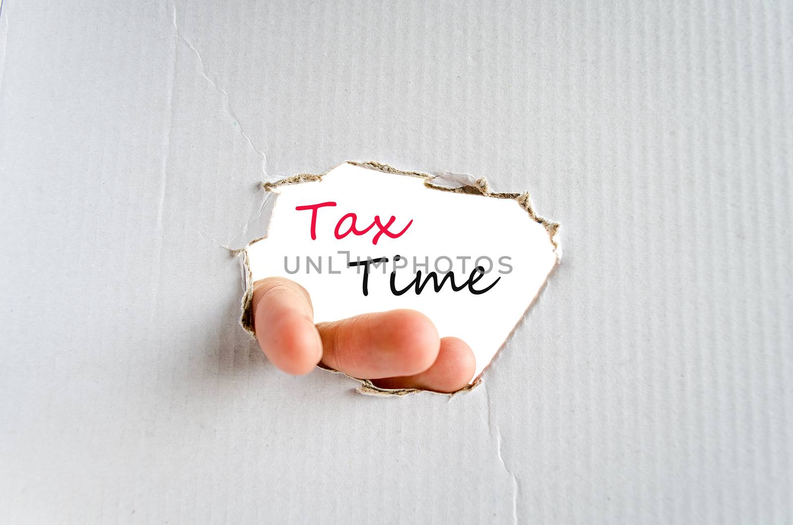 Hand on the cardboard background tax time concept