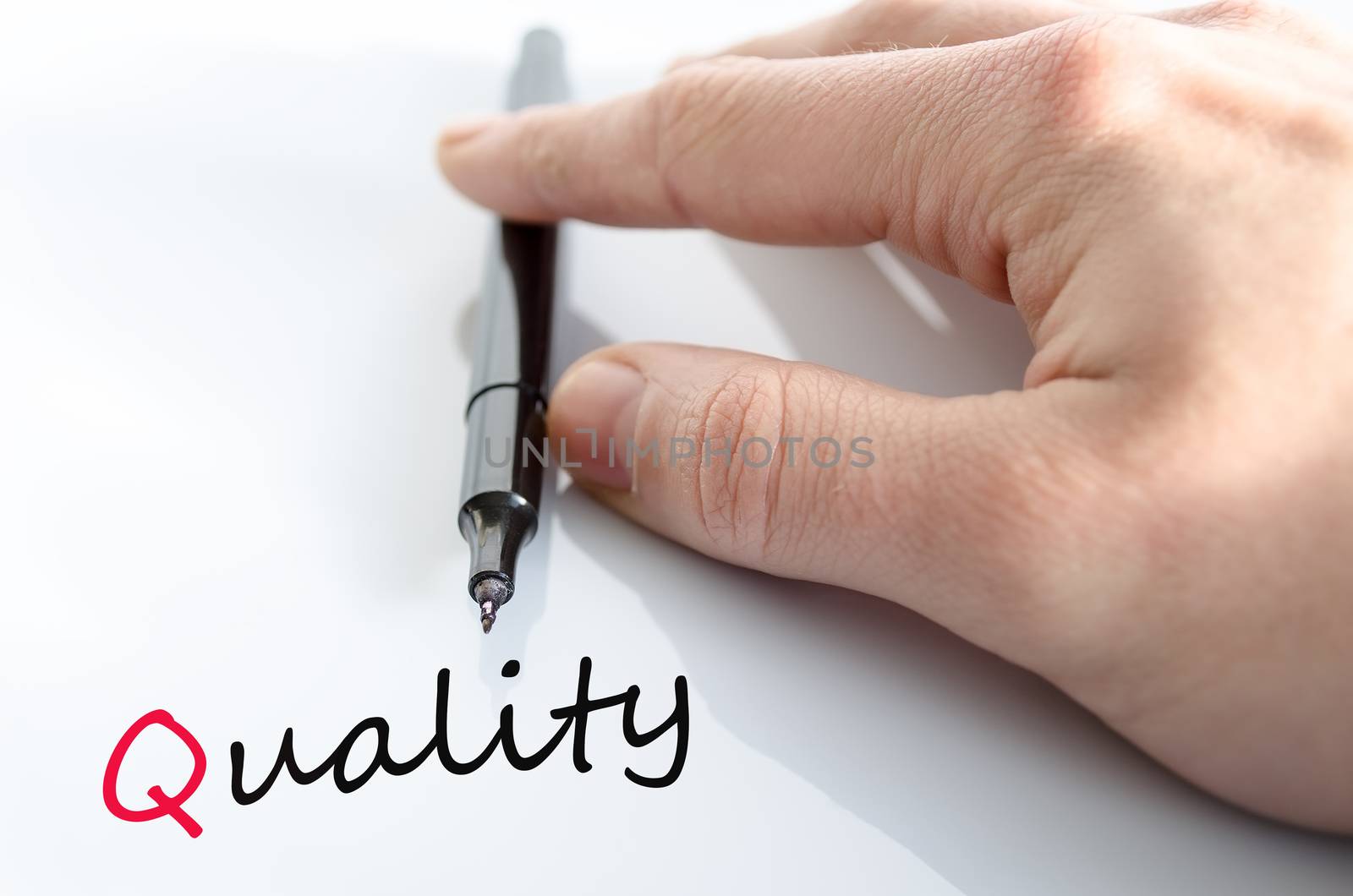 Pen in the hand isolated over white background quality concept