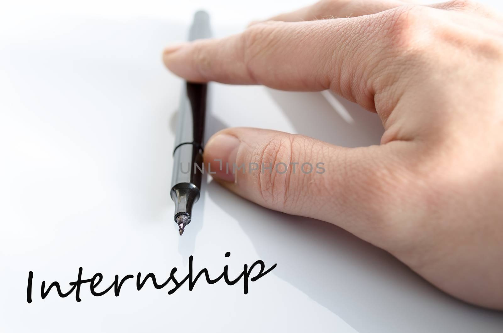 Pen in the hand isolated over white background internship concept