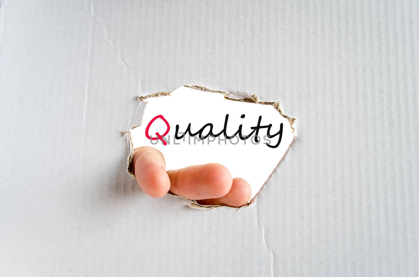 Hand on the cardboard background quality concept