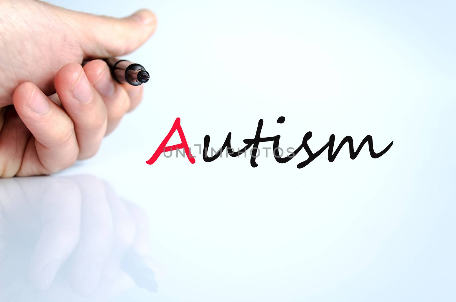 Pen in the hand isolated over white background autism concept