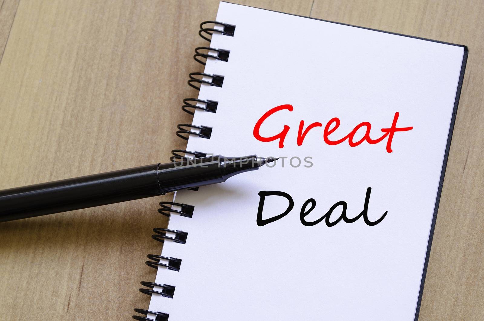 White notepad and ink pen on the wooden desk Great Deal Concept