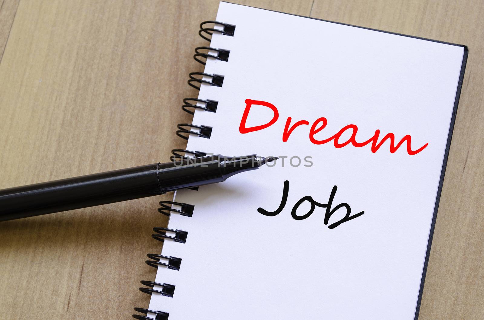 White notepad and ink pen on the wooden desk Dream Job Concept