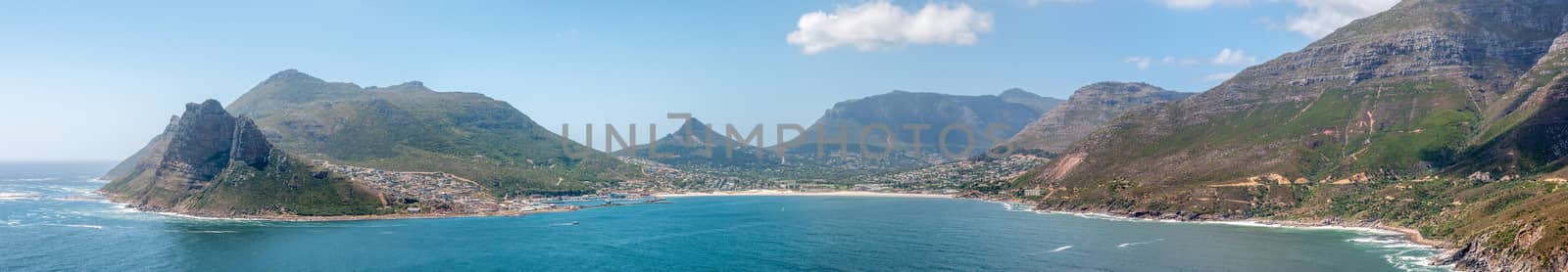 Panorama of Hout Bay harbor and town. Chapmans Peak Drive is visible to the right