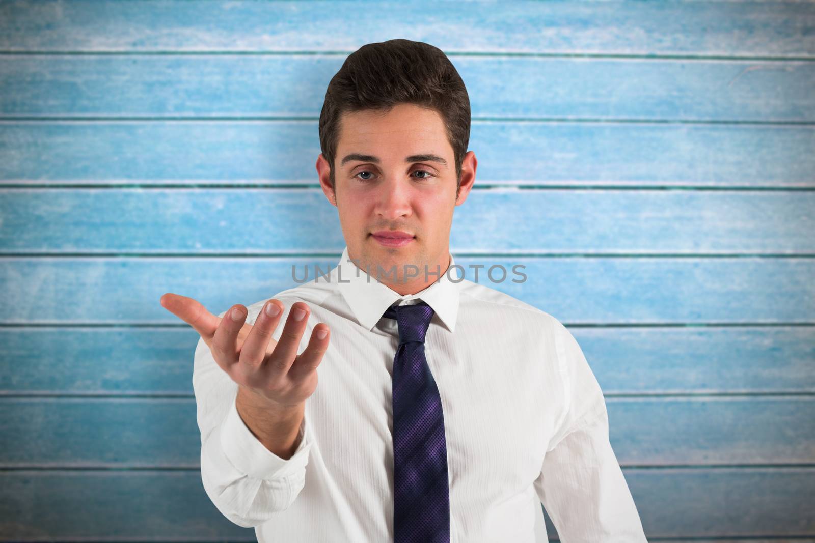Businessman standing with hand out against wooden planks