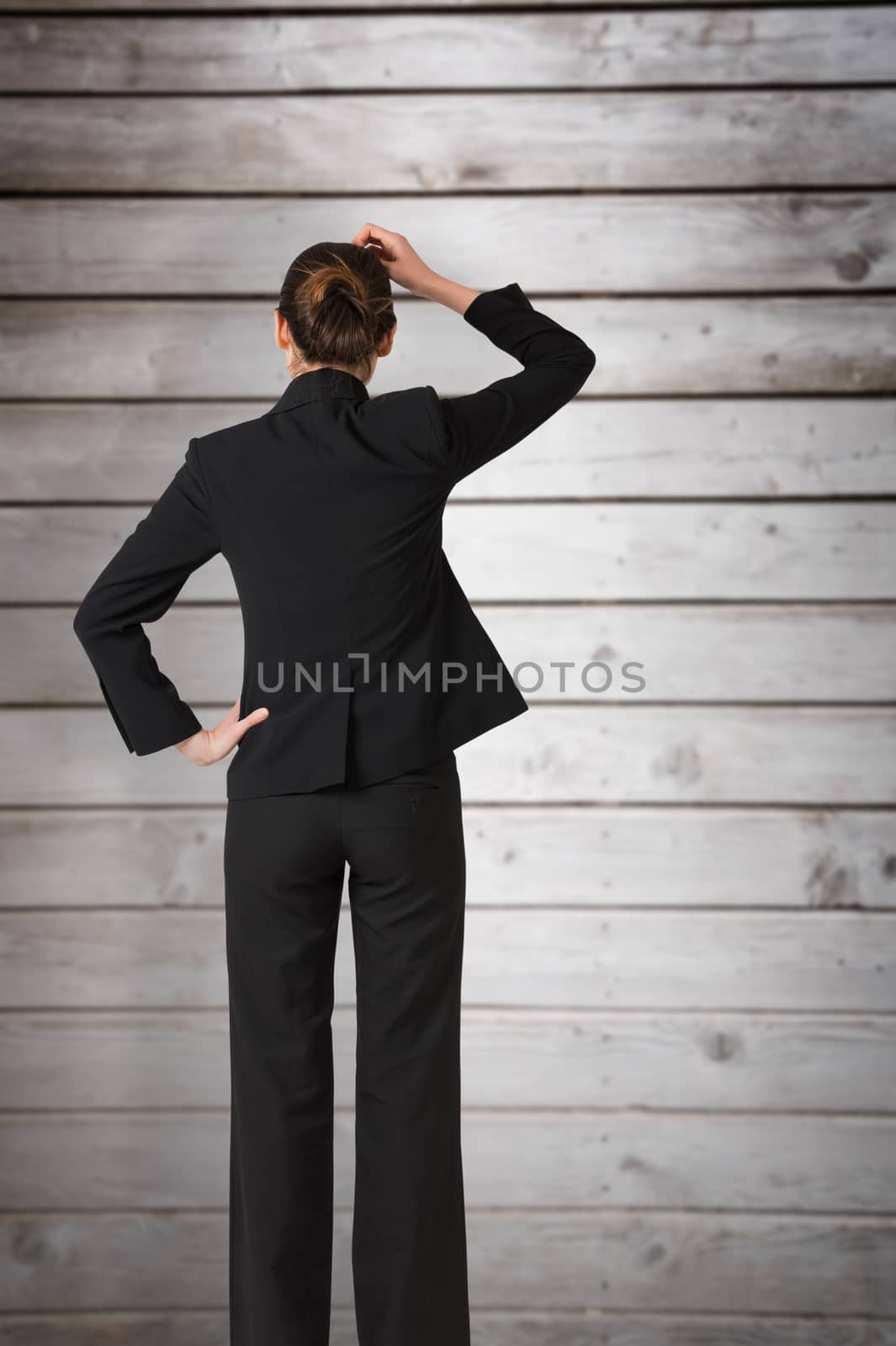 Composite image of businesswoman standing and thinking by Wavebreakmedia