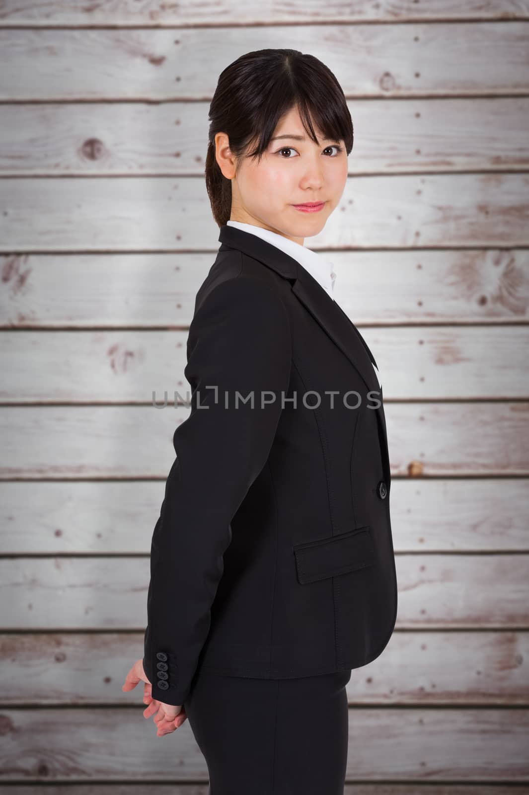 Serious businesswoman against wooden planks