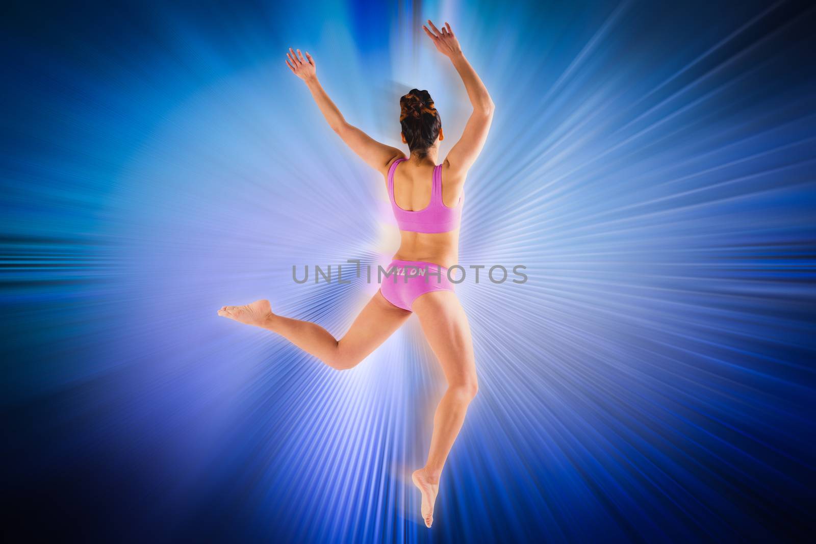 Composite image of fit brunette jumping and posing by Wavebreakmedia