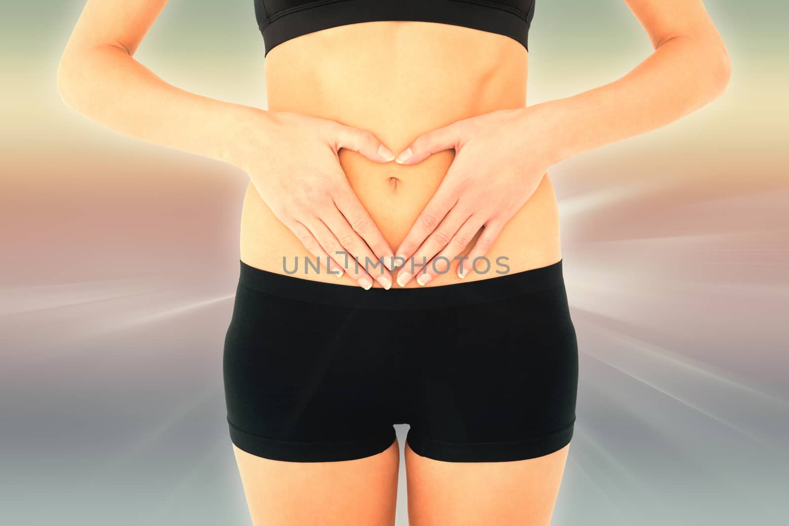 Composite image of closeup mid section of a fit woman in black shorts by Wavebreakmedia