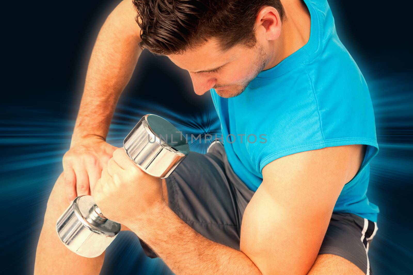 Close-up of a fit man exercising with dumbbell against abstract background