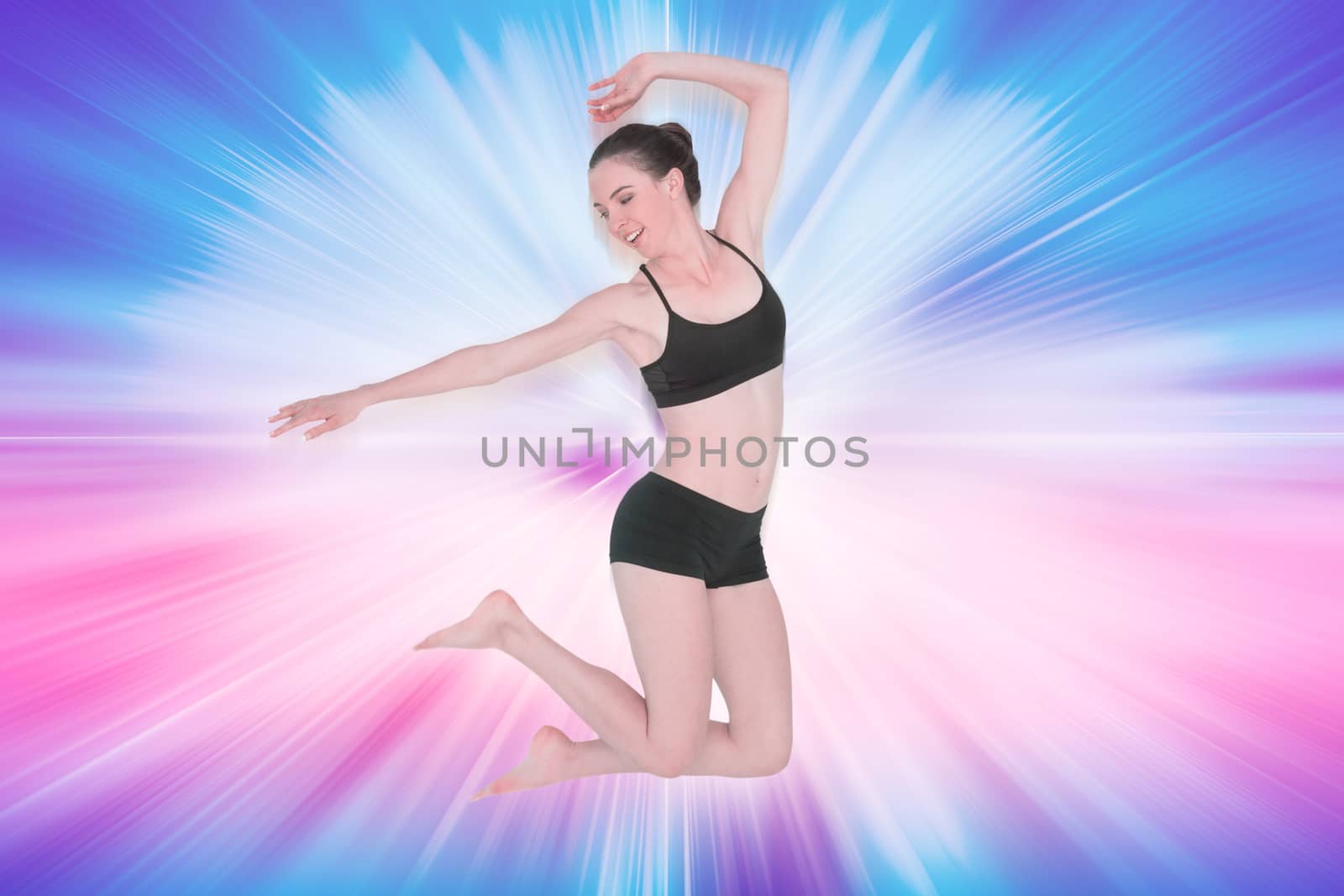 Full length of a sporty young woman jumping against abstract background