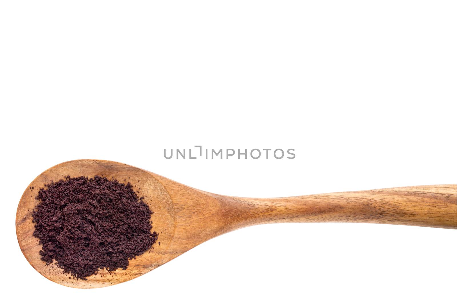 acai berry powder on a wooden spoon isolated on white with a clipping path