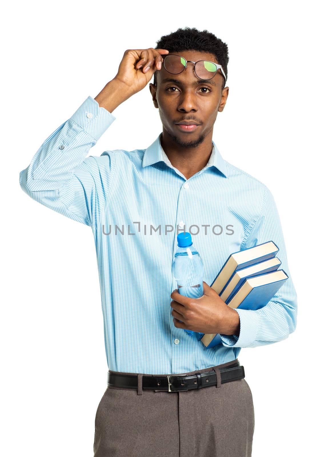 African american college student with books and bottle of water in his hands standing on white background