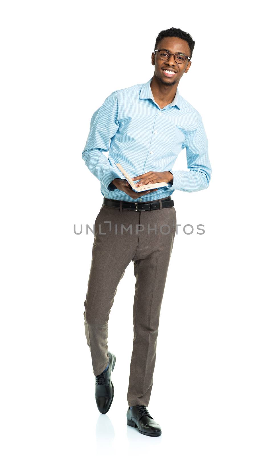 Happy african american college student with book in his hands standing on white background