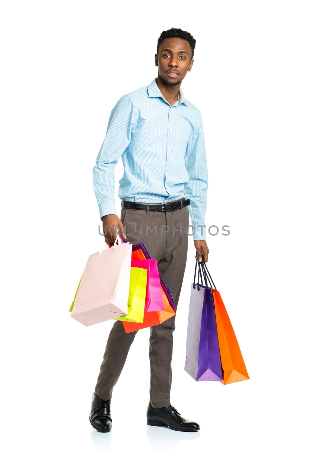 African american man holding shopping bags on white background. Holidays concept
