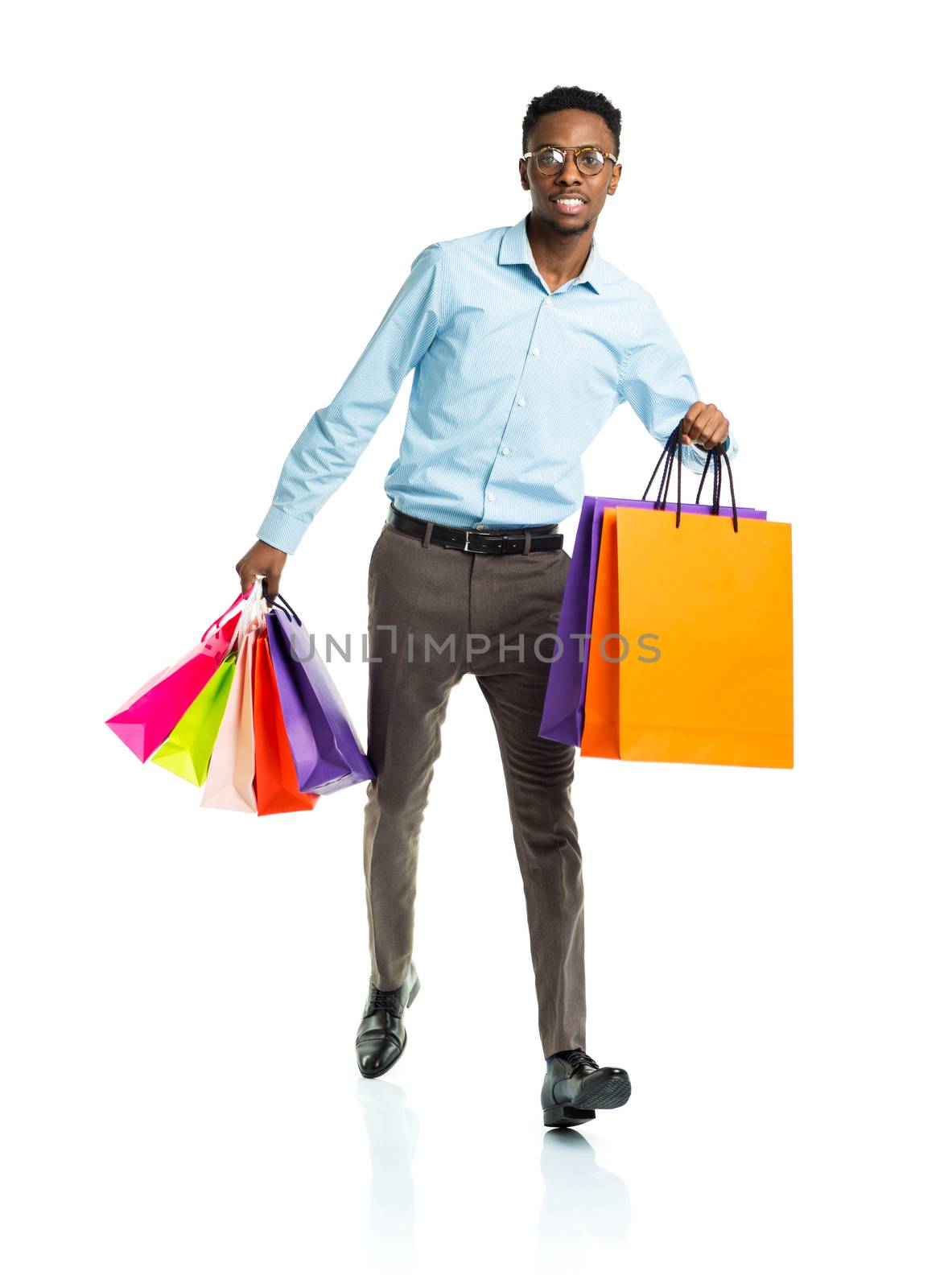 Happy african american man holding shopping bags on white. Holid by vlad_star