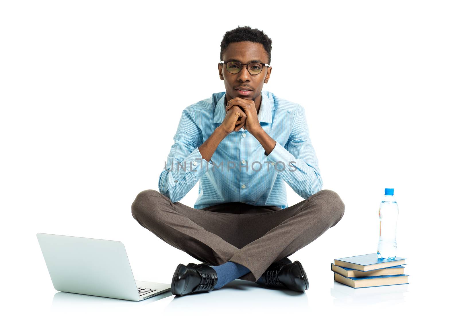 African american college student with laptop, books and bottle of water sitting on white background