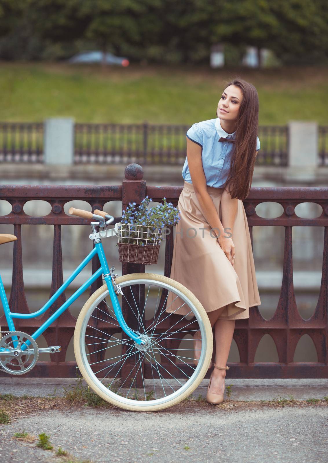 Young beautiful, elegantly dressed woman with bicycle outdoor. Beauty, fashion and lifestyle