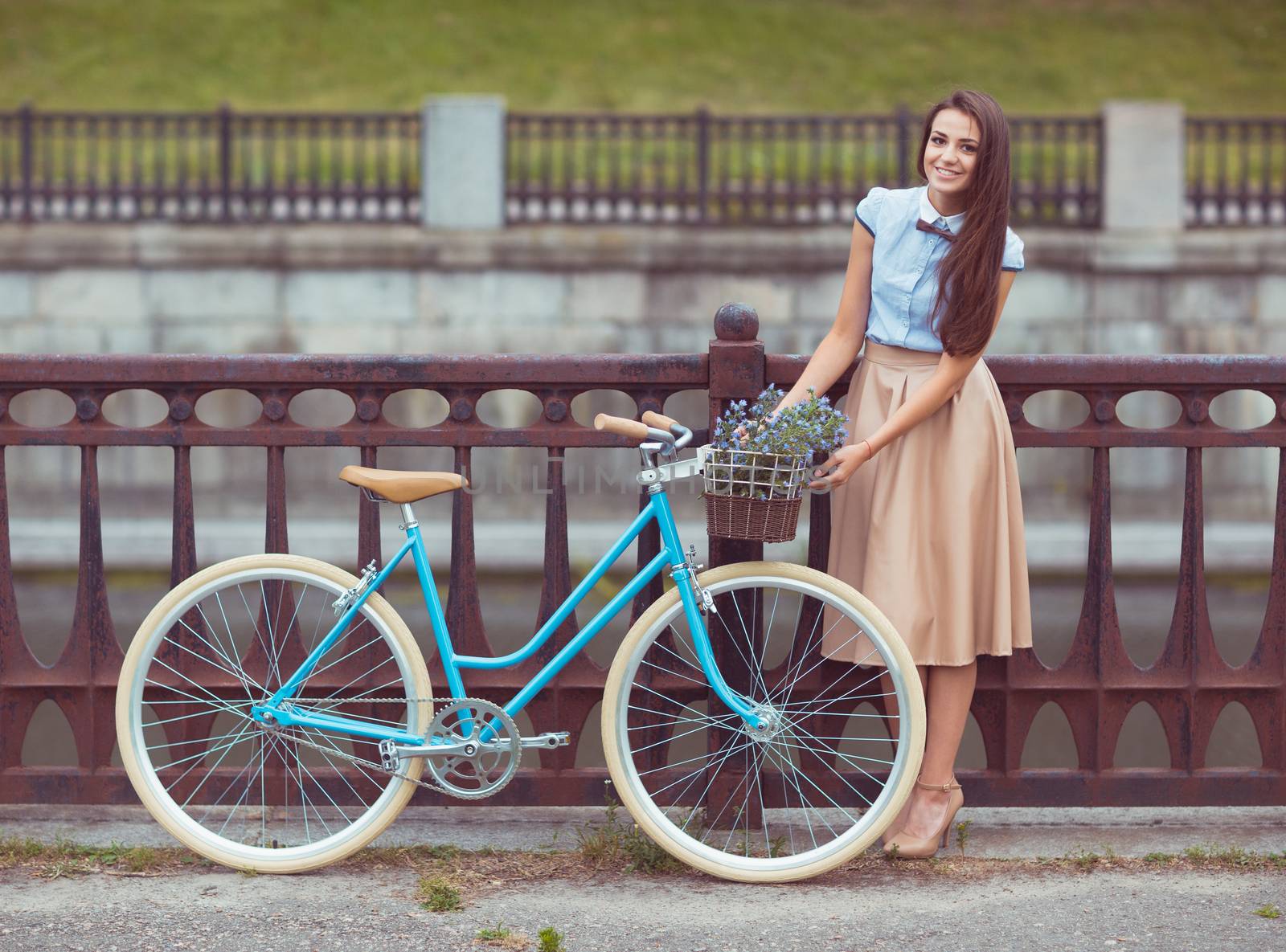 Young beautiful, elegantly dressed woman with bicycle outdoor. Beauty, fashion and lifestyle