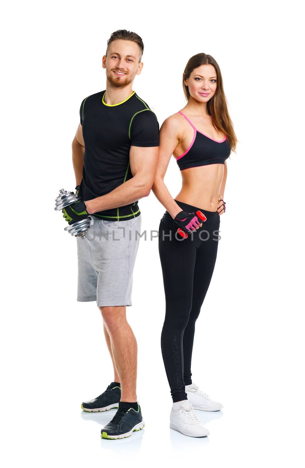 Sport couple - man and woman with dumbbells on the white by vlad_star
