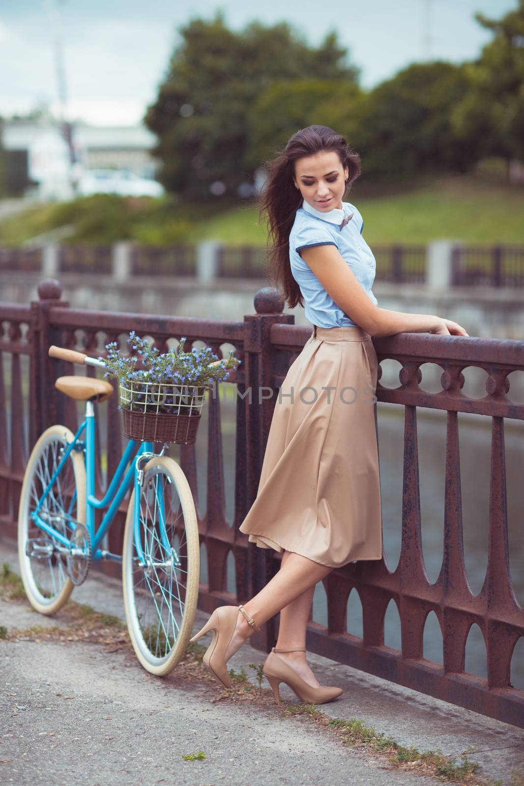 Young beautiful, elegantly dressed woman with bicycle outdoor. Beauty, fashion and lifestyle