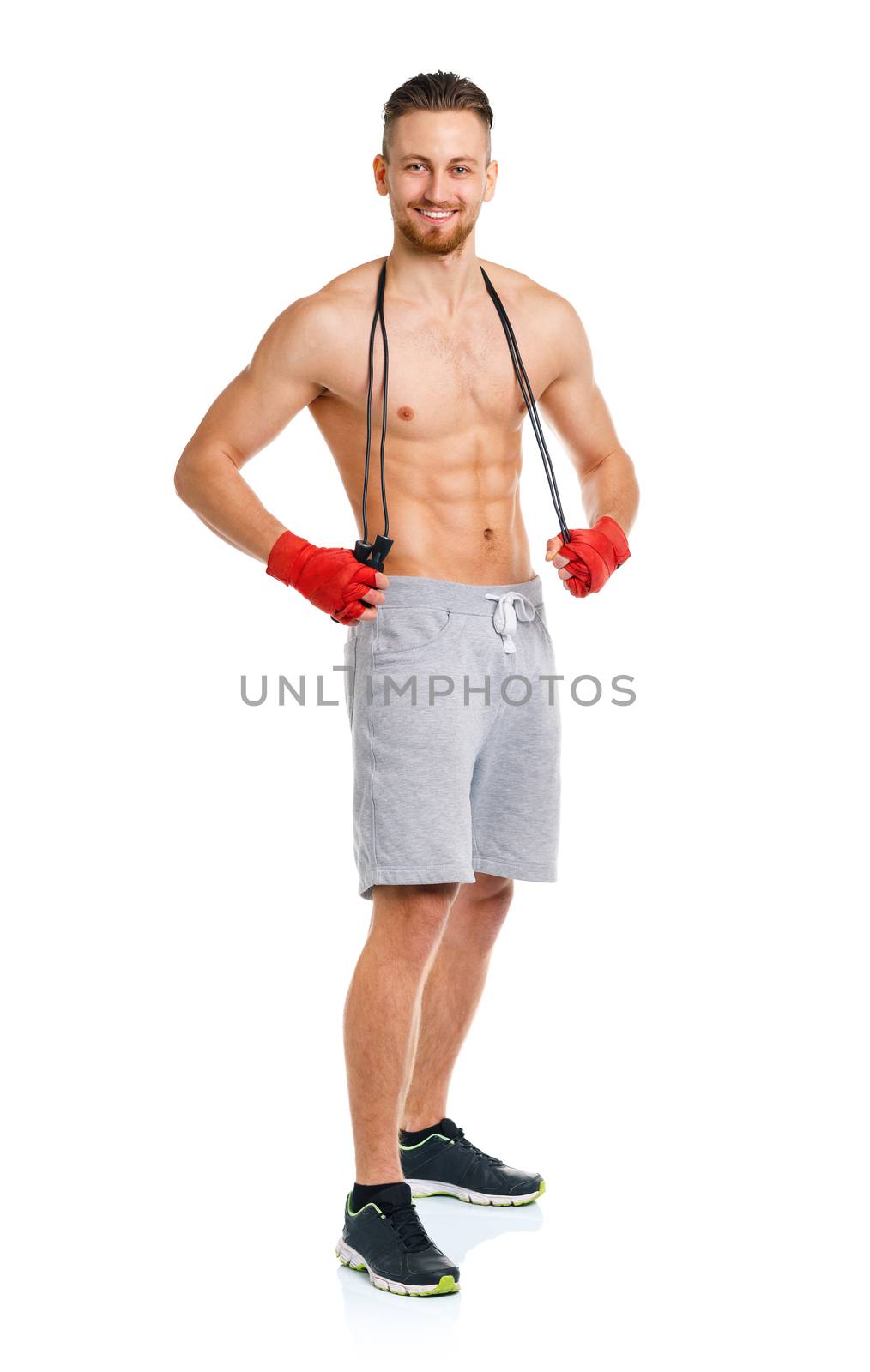 Athletic attractive man with a rope on the white background