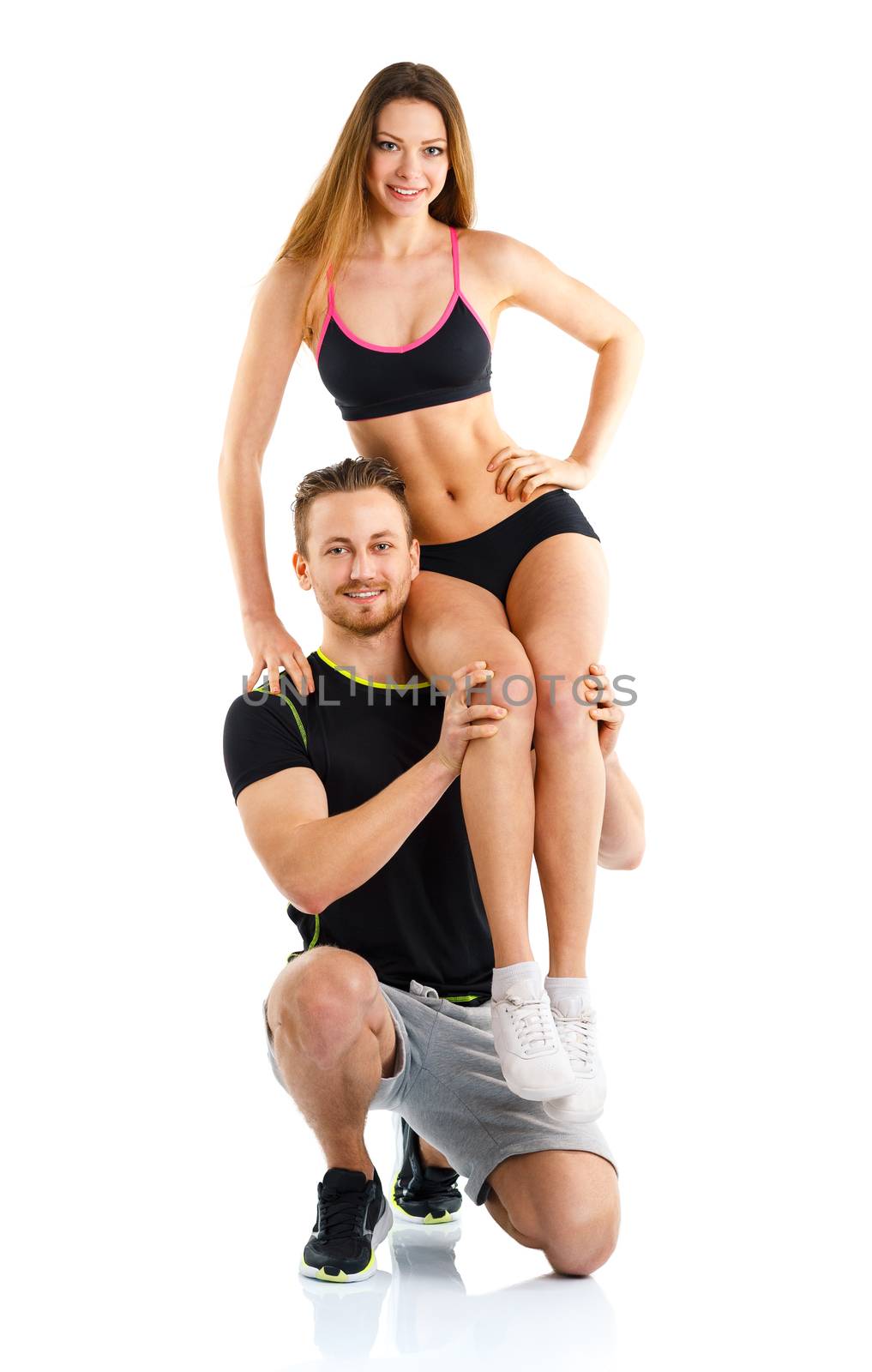 Athletic guy holds on shoulder a girl on a white background