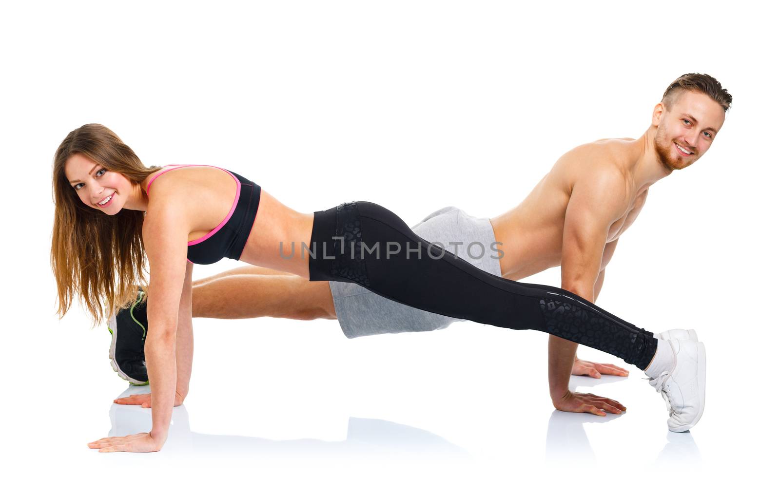 Sport attractive couple - man and woman doing fitness exercises on the white background