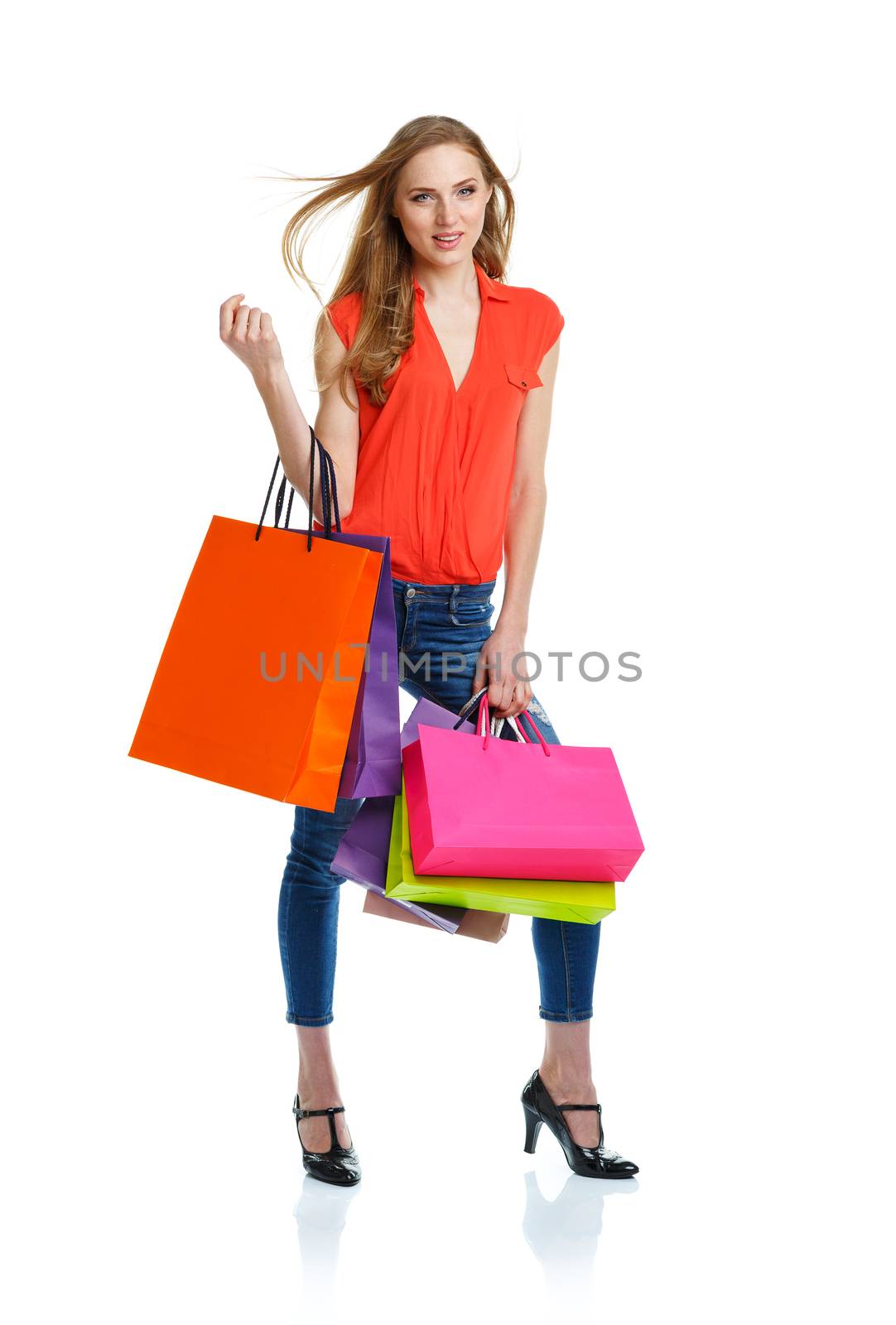Happy lovely woman with shopping bags over white background