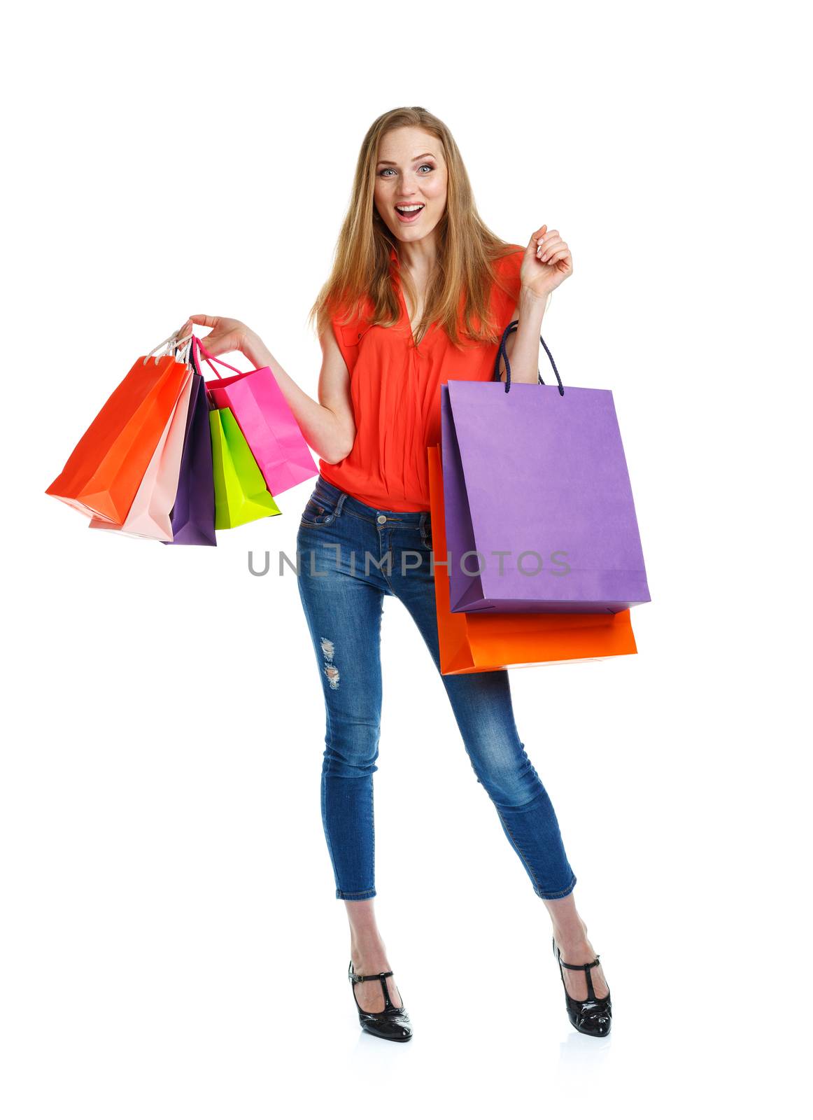 Happy lovely woman with shopping bags over white background